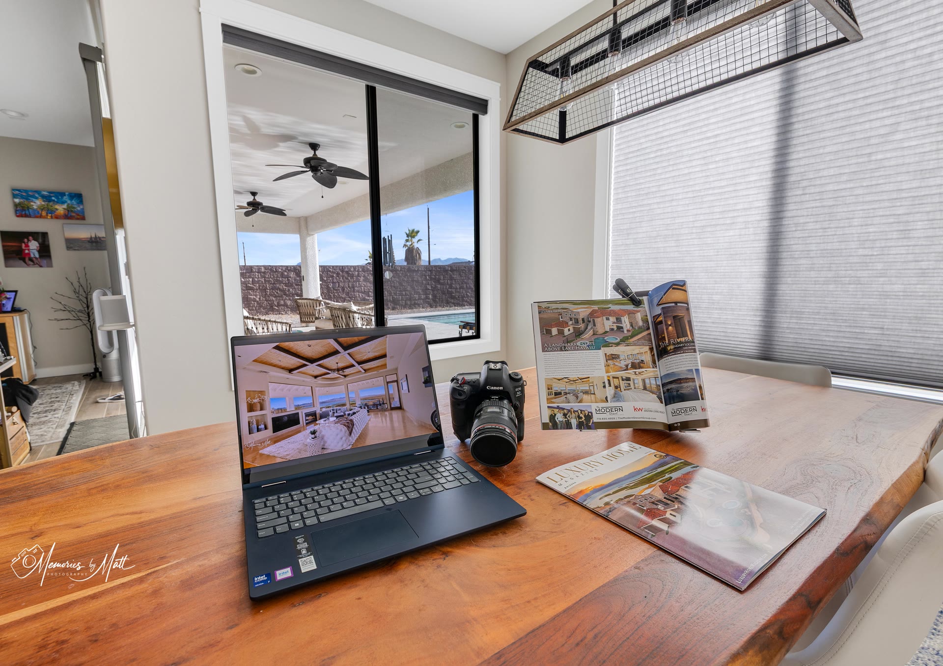 Desk display of real estate photography and Luxury Home Magazine feature